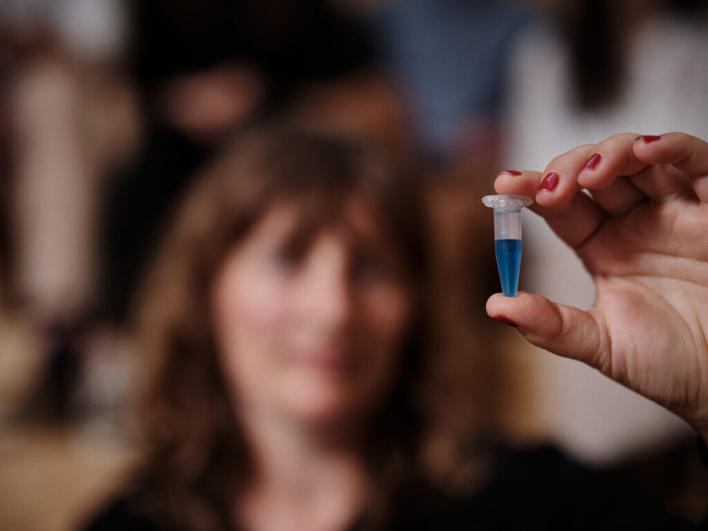 Ditte holding a test tube containing blue liquid